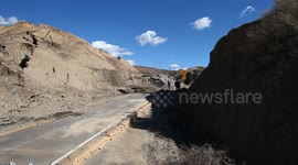 Landslide buckles road in California V19301