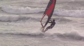 Windsurfers brave powerful Storm Clodagh wind off the coast of Cornwall, UK