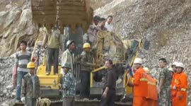 Driver saved after falling rock smashes digger