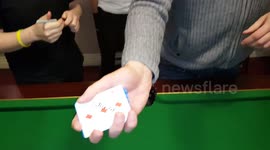 Magician performs incredible card trick by switching cards from mouth-to-mouth