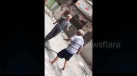 Two elderly men start a comical fight on the street