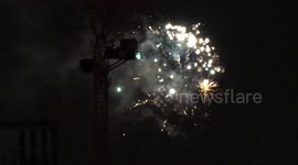 A glimpse of Bonfire Night fireworks outside Battersea Power Station across the River Thames
