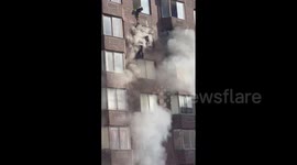 Firefighters rescue woman dangling outside burning NYC apartment building