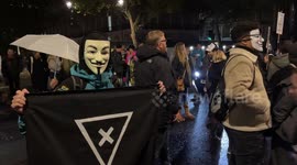 Protesters march wearing Guy Fawkes masks during Bonfire Night in central London