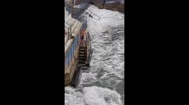 Daredevil takes sea bath in Plymouth while huge waves crash on the shore