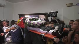 Palestinian mourners carry the body of 18-year-old Musaab Nafal shot by Israeli forces in the West Bank
