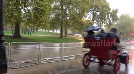 2022 London to Brighton RM Car Run vehicles drive through Wellington Arch in the rain