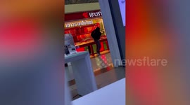 Armed robber smashes glass cabinets to steal gold from shop in Thailand