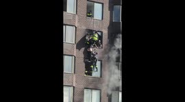 New York firefighters save woman dangling from burning high-rise building