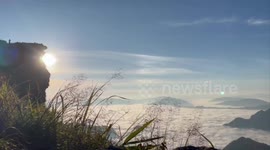 Tourists climb mountain to marvel at sea of clouds amid cooler weather in northern Thailand