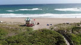 Despite incoming hurricane, South Florida beachgoers brave high wind and pounding surf