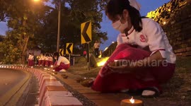 Clay pot lanterns line streets as locals hold religious festival in Thailand