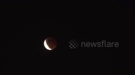 Spectacular lunar eclipse seen as locals celebrate Buddhist festival in Thailand
