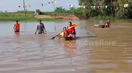 Thai villagers celebrate Buddhist festival with water boxing and basin race