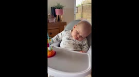 This baby could barely stay awake while eating breakfast