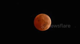 Lunar eclipse above Honolulu, Hawaii, USA
