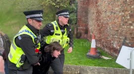 Footage shows moment police detain activist who threw eggs at King Charles and Queen Camilla