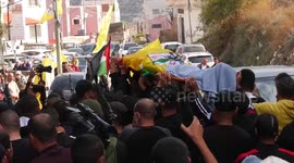 Palestinians carry the body of Raafat Issa, who was shot killed by Israeli forces, during his funeral in the West Bank city of Jenin