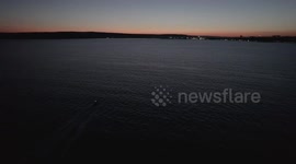 Drone camera chases a boat in the Black Sea off the coast of Varna at sunset