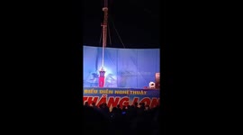 Two men perform balancing on their shoulders over an iron bar