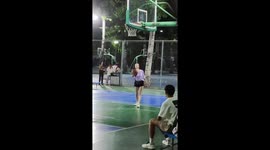 Chinese gymnast performs somersault pass during basketball game