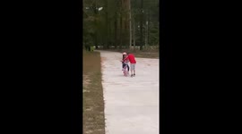Cheerful older brother hypes up little sister for riding her bike without training wheels