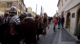 The procession of St. Martin on a white horse across Charles Bridge in Prague, Czechia