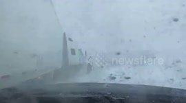 Truck's trailer slams into car on icy road due to blizzard in North Dakota