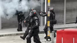 Police fire tear gas at university students protesting the increase in rapes of women on public transport in Bogotá.
