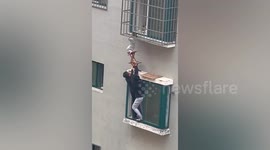 Neighbours rescue boy dangling from 4th-floor window in China