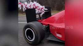 Motorist drives F1 car home with Christmas tree strapped to the back in France