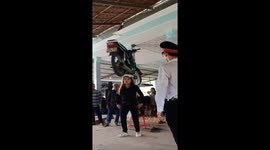 Woman uses head to lift motorbikes