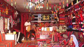 Palestinians display heritage works for sale to support handicrafts and traditional industries at a shop