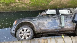 A stretch of canal has been closed after a CAR was mysteriously found submerged by water in a lock