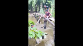 Fail! Guy wants to throw friend into river, but falls instead