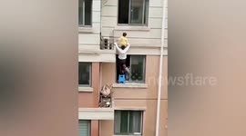 Neighbour rescues 4-year-old hanging from 5th floor window in China