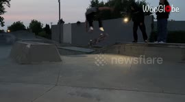 Skateboarder accidentally swings board at his friend holding camera