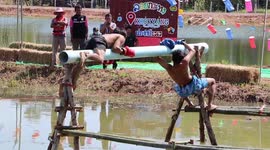 Locals take part in amusing 'water boxing' duels on pole over swamp in Thailand
