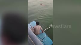 Police officers rescue drowning dog from river in western India