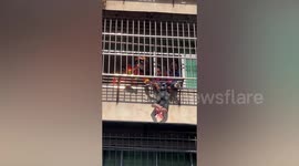 Elderly Chinese man scales building to rescue child hanging from 3rd-floor window