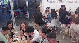 Embarrassing moment clumsy cafe customer falls off stool while leaning back