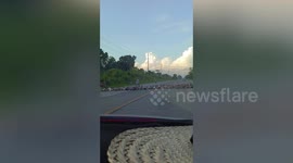 Hundreds of ducks cross road together like having parade
