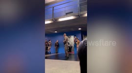 Royal staff kneel in lift while Thai king's wife carries pet dog from concert