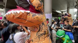 Protesters wear dinosaur suits at rally against APEC 2022 summit in Bangkok, Thailand