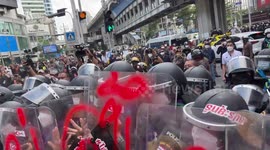 Protesters kick riot police shields at rally against APEC summit in Thailand