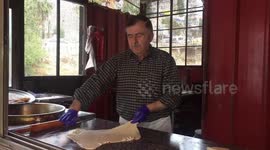 Palestinian man Tawfiq Ashqalan, prepares sweet known in Arabic as