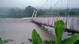 Bridge collapses as rain-swollen river erodes its foundation in the Philippines