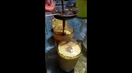 2 - Roadside cook uses electric drill to mixes stamina-generating 'egg tea' in Indonesia