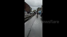 Tower Bridge flooded as rain batters London