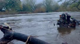 River Wharfe in West Yorkshire fast flowing with flooding in surrounding roads.